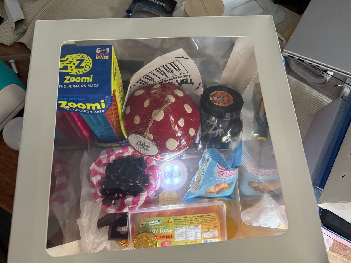 Example custom gift box with confectionery, a maze puzzle and decorative items; contents sold separately