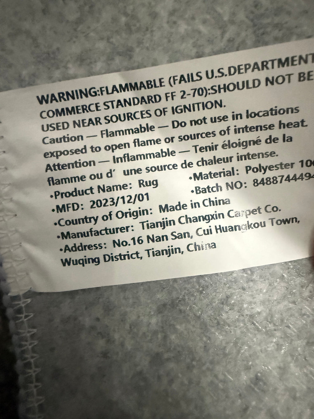 Rug label showing polyester composition and flammability warning