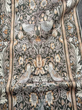 Dark botanical rug with pale birds, flowers, leaves and an ornamental border