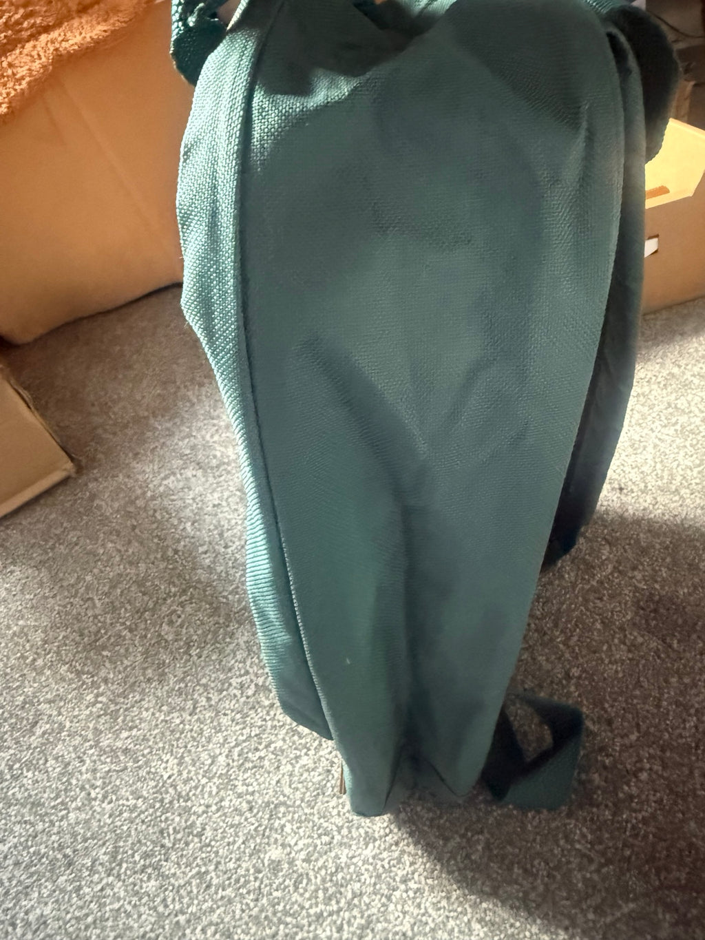 Side view of the Madison & Dakota green rucksack